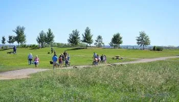 People walking dogs at Oxbows Off Leash Dog Park.